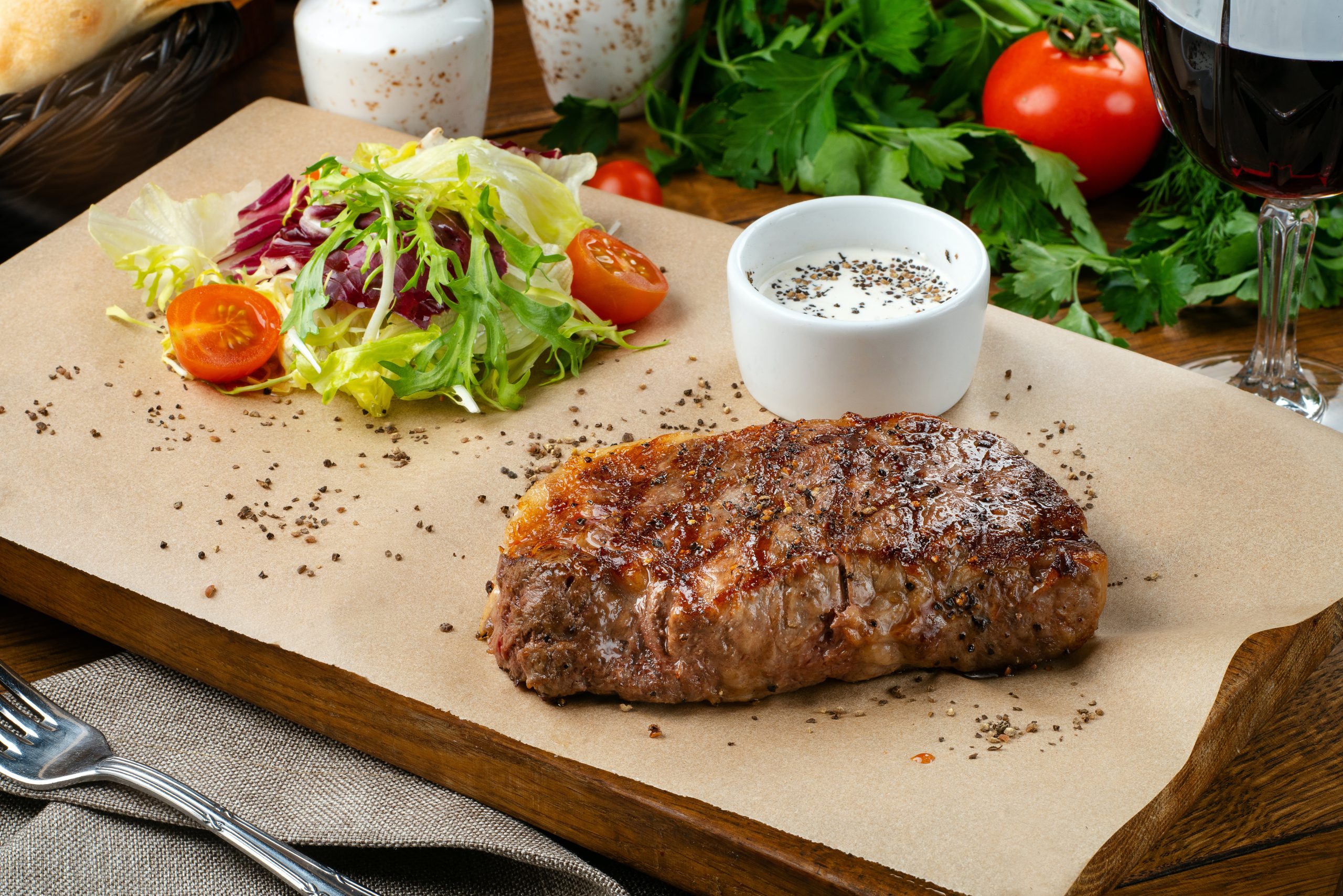 juicy, marinated meat with our kitchen gadget on a serving board with a dipping sauce and salad.